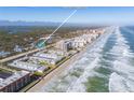 Aerial view showing home's location near beach and other buildings at 4200 Sun Village Ct # 33D, New Smyrna Beach, FL 32169