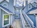 Rear view of the building showcasing stairs and walkway access to units at 4208 Sun Village Ct # 4208, New Smyrna Beach, FL 32169