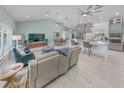 Open living room and kitchen with vaulted ceilings, hardwood floors, and modern fixtures at 4324 Candlewood Ln, Ponce Inlet, FL 32127