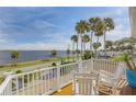 Relaxing balcony with white chairs overlooking the waterfront at 4946 Halifax Dr, Port Orange, FL 32127