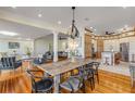 Open concept dining room with rustic farmhouse table and adjacent kitchen at 4946 Halifax Dr, Port Orange, FL 32127