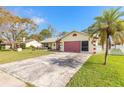 Paved driveway leading to a single-car garage with a screened enclosure and a white picket fence at 5583 Miles Dr, Port Orange, FL 32127