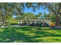 Mid-century modern home with covered patio and lush landscaping at 645 Yupon Ave, New Smyrna Beach, FL 32169