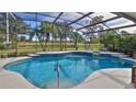 Inviting pool with a screen enclosure, overlooking a golf course at 839 Fairway Dr, New Smyrna Beach, FL 32168