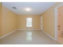 Bright bedroom with tile floors and a large window at 5025 E Lake Mary Blvd, Sanford, FL 32771