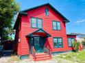 Two-story red house with green trim and brick steps at 415 Braddock Ave, Daytona Beach, FL 32118