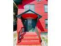 Front entrance with green door and brick steps at 415 Braddock Ave, Daytona Beach, FL 32118
