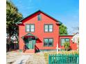 Two-story red house with green trim and picket fence at 415 Braddock Ave, Daytona Beach, FL 32118