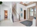 Bright and spacious entryway with a modern staircase and art at 4157 Grande Brick Loop # 18, Orlando, FL 32837