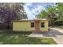 Yellow single story house with a small yard at 14650 Liberty St, Orlando, FL 32826