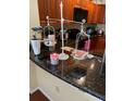 Kitchen breakfast bar with granite countertop and decorative items at 1321 Arbor Vista Loop # 209, Lake Mary, FL 32746
