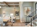 Elegant dining area with hardwood floors, wood beams, and modern light fixture at 4181 Grande Brick Loop # 22, Orlando, FL 32837