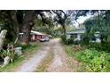 Gravel driveway, red house, and mobile home at 770 Snow Hill Rd, Geneva, FL 32732