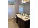 Clean bathroom with dark vanity and updated fixtures at 1023 W Gore W St, Orlando, FL 32805
