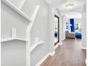 Bright hallway with built-in shelving and wood floors at 14501 Grove Resort Ave # 1430, Winter Garden, FL 34787