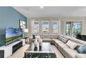 Spacious living room with large sectional sofa and flat screen tv at 5288 Oakbourne Ave, Davenport, FL 33837