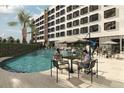 Resort-style pool with lounge chairs, tables, and umbrellas at 4849 W Irlo Bronson Hwy # 534, Kissimmee, FL 34746