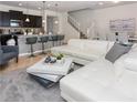 Open living space featuring a sectional sofa and a modern coffee table at 8890 Geneve Ct, Kissimmee, FL 34747