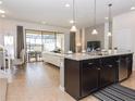 Modern kitchen with island, granite countertops, and stainless steel appliances at 8890 Geneve Ct, Kissimmee, FL 34747