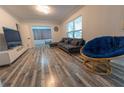 Living room with gray sectional sofa and blue chair at 2627 Ambergate Rd, Winter Park, FL 32792
