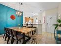 Bright dining area with a large wooden table and seating for six at 8407 Blue Lagoon Dr, Kissimmee, FL 34747