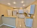White kitchen with granite countertops and a breakfast bar at 10401 Larissa St, Orlando, FL 32821