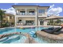 Luxury pool with spa, lounge chairs, and outdoor dining area at 580 Muirfield Loop, Reunion, FL 34747