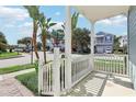 Charming front porch with white railings, offering a view of the neighborhood at 1554 Fairview Cir, Kissimmee, FL 34747