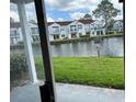 View of a canal and neighboring townhouses from a patio at 2512 Woodgate Blvd # 104, Orlando, FL 32822