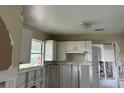 A kitchen undergoing renovation, showing exposed walls and framing at 2512 Woodgate Blvd # 104, Orlando, FL 32822