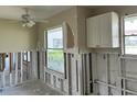A kitchen under renovation, with damaged walls and exposed plumbing at 2512 Woodgate Blvd # 104, Orlando, FL 32822