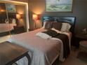 Bedroom with queen bed and mirrored closet at 715 S Beach St # 306D, Daytona Beach, FL 32114