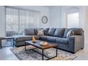 Bright living room featuring a large sectional sofa and stylish coffee table at 8879 Cabot Cliffs Dr # 102, Davenport, FL 33896