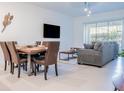 Open living and dining area with tile floors at 8879 Cabot Cliffs Dr # 102, Davenport, FL 33896