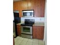 Kitchen with stainless steel appliances and wood cabinets at 11514 Westwood Blvd # 413, Orlando, FL 32821