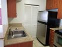 Kitchen with stainless steel appliances and wood cabinets at 11514 Westwood Blvd # 413, Orlando, FL 32821