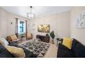 Bright living room featuring comfortable seating, a large TV, and stylish decor at 165 Captain Hook Way, Davenport, FL 33837