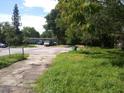 Vacant lot with overgrown grass and street view at 4022 Shellman St, Orlando, FL 32811