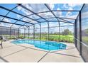 Screened pool and patio overlooking a tranquil lake at 330 Ballo Dr, Kissimmee, FL 34746