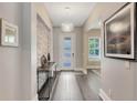 Bright entryway with stone accent wall and modern console table at 1871 Taylor Ave, Winter Park, FL 32789