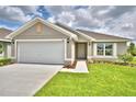 One-story house with a two car garage and front yard at 1278 Tagliamento Ln, Haines City, FL 33844