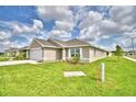 One-story house with a garage and well-maintained lawn at 1278 Tagliamento Ln, Haines City, FL 33844