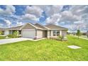 One-story house with a two-car garage and landscaped yard at 1278 Tagliamento Ln, Haines City, FL 33844
