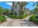 Townhouse exterior with circular driveway and landscaping at 2958 Lucayan Harbour Cir # 108, Kissimmee, FL 34746