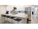 Modern kitchen with island, stainless steel appliances and breakfast bar at 17428 Hidden Forest Dr, Clermont, FL 34714