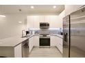 Modern kitchen with stainless steel appliances and gray counters at 17428 Hidden Forest Dr, Clermont, FL 34714