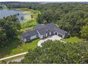 Lakefront home with a large yard and circular driveway at 260 Deer Isle Dr, Winter Garden, FL 34787
