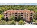 Large three-story building with tile roof and parking at 1375 Tuscana Ln # 1308, Davenport, FL 33896