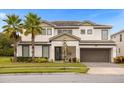 Two-story house with palm trees and a large garage at 3951 Oakville Ave, Kissimmee, FL 34741