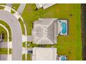 Aerial view of a house with a pool, and surrounding neighborhood at 3951 Oakville Ave, Kissimmee, FL 34741